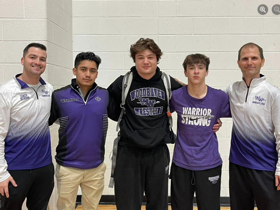 Marcello Luna stands proud with his fellow wrestling coaches and state-bound wrestlers Jake Navarro and Koen Huepenbecker at the close of regionals. 