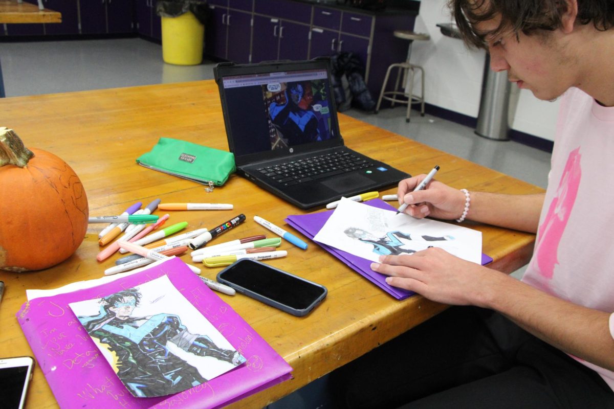 Wyatt Braun works with a reference image.