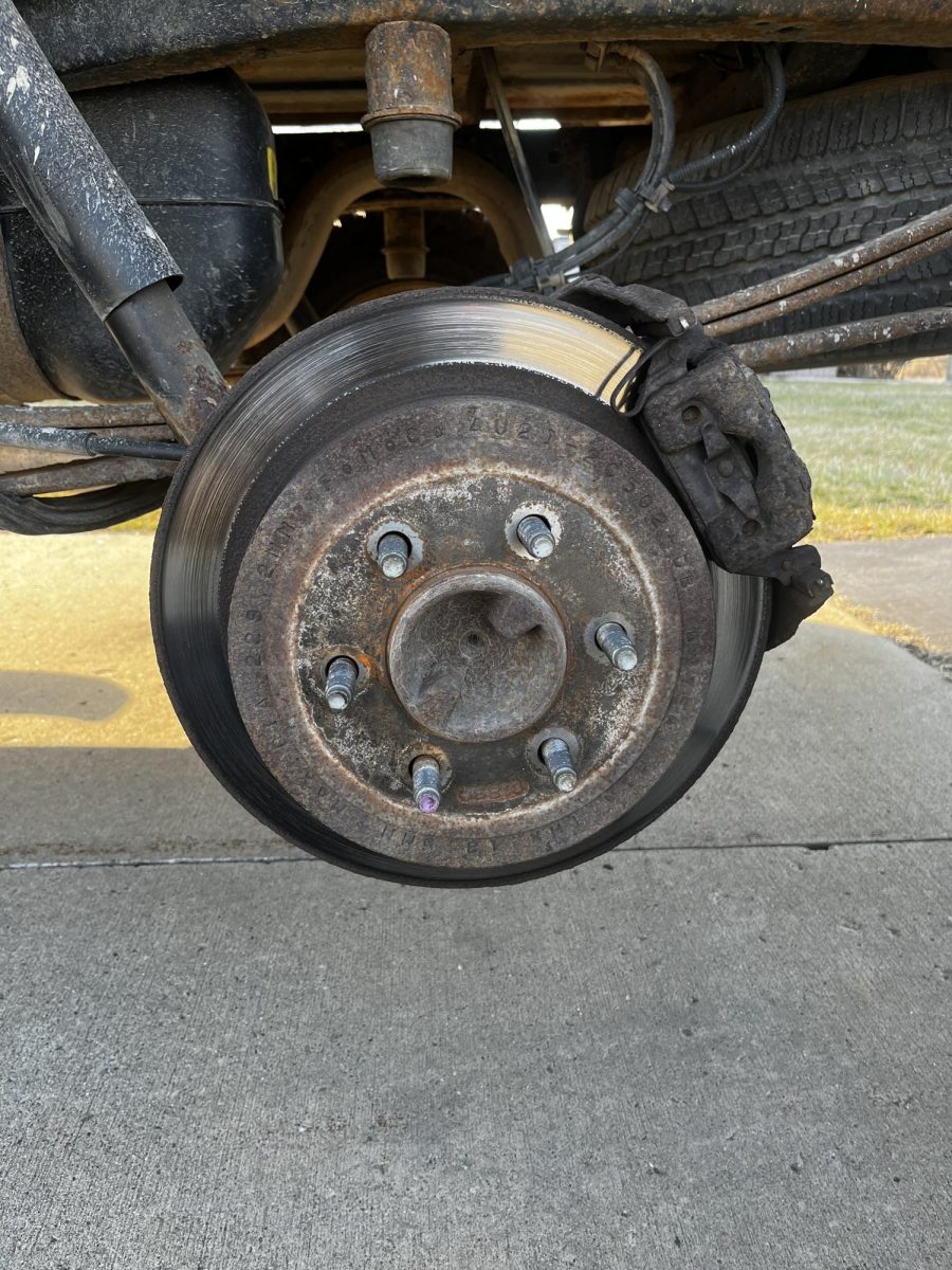 Remove the tire off the hub, which is the rods that the nuts were tightened onto. At this point, you can put the spare tire on and move the old one off to the side. Remember to replace the temporary tire as soon as possible.